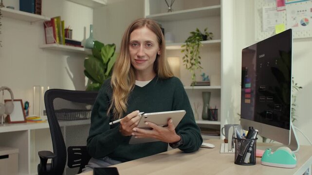 Confident woman coach teaching an online course from her home office, embracing the creator economy and remote education to empower others through virtual learning and on-demand expertise coaching