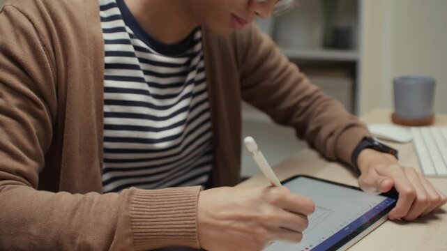 Modern man freelancer working remotely from home office, using a laptop to manage outsourced digital tasks and collaborate with global clients, embracing the freedom to work anytime and anywhere