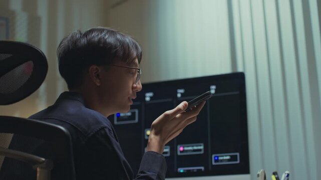 Modern man freelancer using AI voice assistant to make hands-free searches while working remotely, boosting productivity, embracing smart technology in a flexible work environment