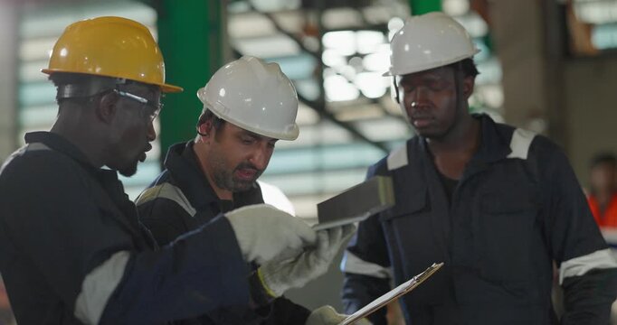 Factory technician inspecting auto parts, metal rod at machining station