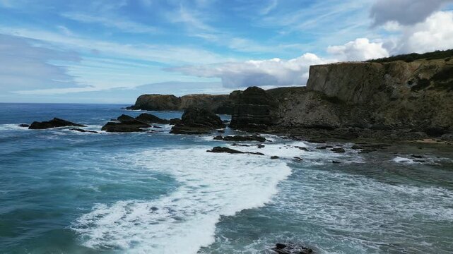 Aerial drone footage of Praia da Am&aacute;lia, Portugal: hidden beach, rugged cliffs and wild Atlantic coastline under natural light. Ideal for travel, nature and summer projects.