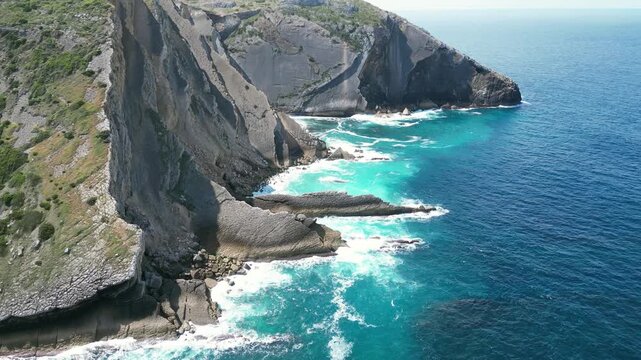 Aerial drone footage of Cabo Espichel, Portugal: dramatic Atlantic cliffs, rugged coastline and vast ocean landscape under natural light. Ideal for travel and nature projects.