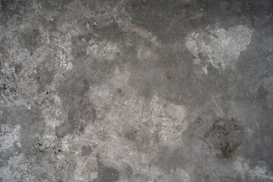 Textured gray concrete surface with subtle stains and imperfections.