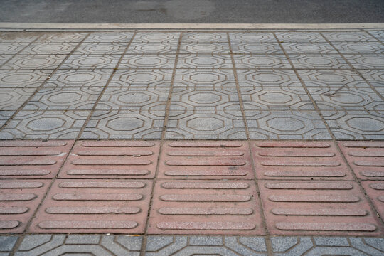 Close-up of patterned concrete pavement with contrasting colors and textures.