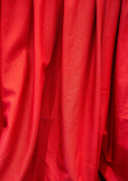 Rich red fabric draped elegantly, adding a vibrant touch to any setting.