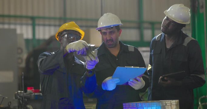 Factory technician inspecting auto parts, metal rod at machining station