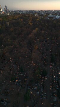 Aerial flyover of Warsaw Cemetery on All Saints' Day in autumn at sunset