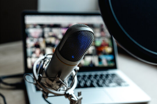 Radio broadcasting studio with podcast equipment: microphone and laptop
