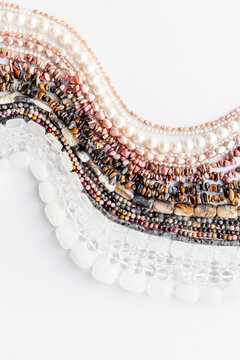 Necklaces of many gemstones beads and pearls, top view. Jewelry concept.