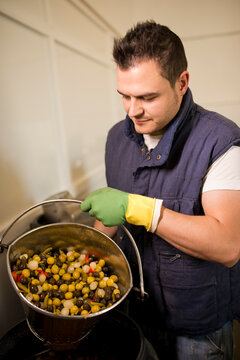 Man in olives factory manufacturing showing olives bucket