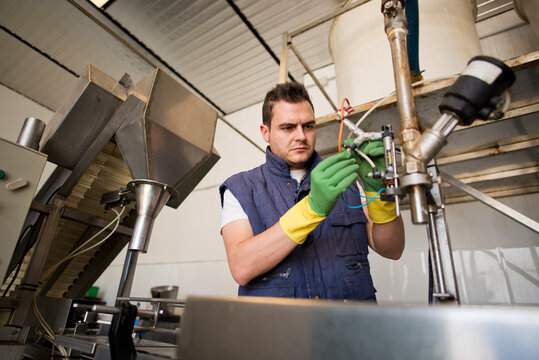 Worker programming and reparing factory machine