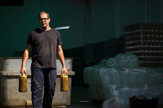 Real worker with two olives garafes
