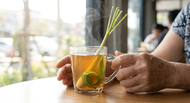Hot ginger tea with lemongrass and pandan in clear glass mug