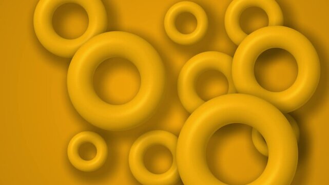 Abstract 3d animation of yellow rings floating slowly against a matching background.