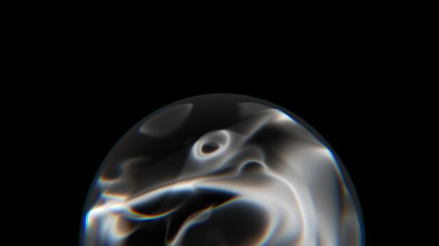 Macro shot of an iridescent glass dome with colorful light refractions and caustic patterns against a solid black background
