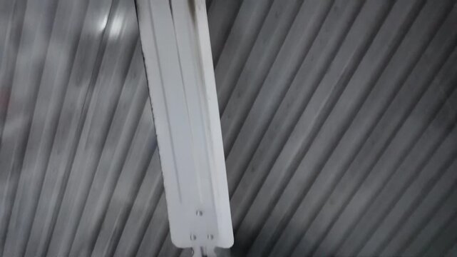 A video showcasing a ceiling fan in a room with a wooden ceiling