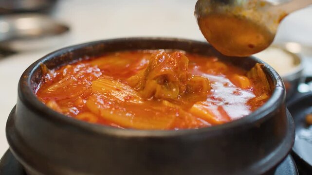 Spicy Korean Kimchi Jjigae Stew Served in a Traditional Stone Pot
