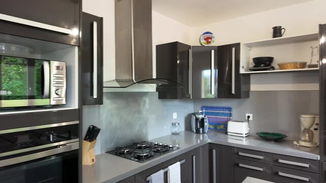 Modern Kitchen Interior with Gray Cabinets and Stainless Steel Appliances in Paris
