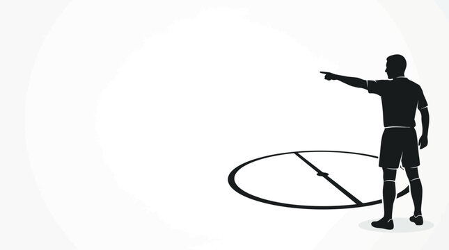 Silhouette of a soccer referee pointing on the field.