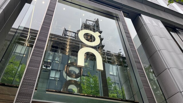 On Running brand logo and modern glass facade of the flagship retail store showcasing contemporary Swiss athletic apparel architecture - Osaka, Japan, October 16, 2025