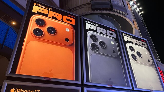 Apple iPhone 17 Pro outdoor advertisement posters for NTT Docomo featuring new color variants on a street display in the Shibuya district - Tokyo, Japan, October 17, 2025