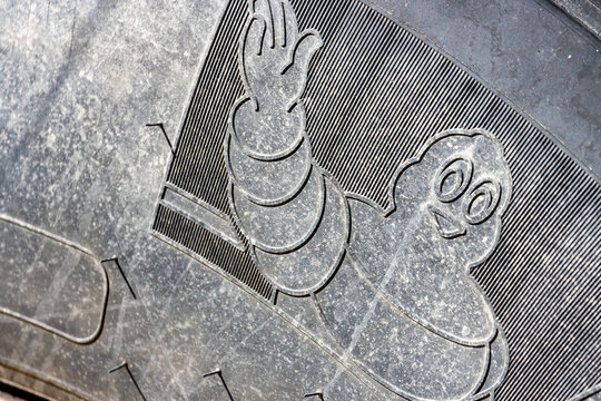 Quebec, Canada, 27 April 2026 : The iconic Michelin Man logo is embossed on the tread of a used tire.