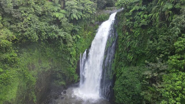 Aerial Drone Footage of Gomblang Waterfall in Dense Tropical Forest, Java Indonesia