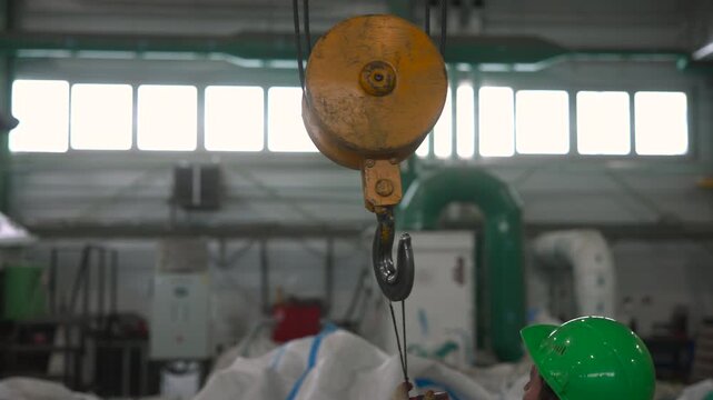 Personnel Examine Overhead Crane Systems To Ensure Industrial Safety Protocols Are Maintained . Media