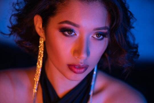 Enchanting night allure of a young woman in vibrant club atmosphere