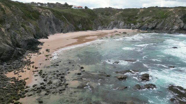 Aerial drone footage of Praia da Am&aacute;lia, Portugal: hidden beach, rugged cliffs and wild Atlantic coastline under natural light. Ideal for travel, nature and summer projects.
