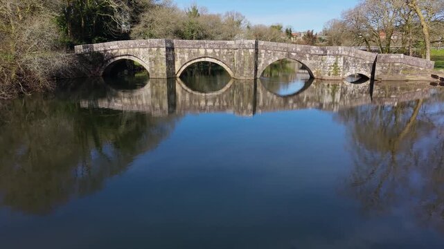 Ponte Romana de Brandomil (Brandomil Bridge), Historic Stone Bridge In Zas, Spain. Aerial Pullback Shot