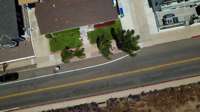 Drone pulling back at Mission Bay Park in San Diego California with camera facing down and slowly tilting up to reveal the surrounding community.