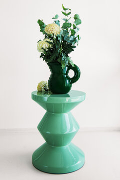 furniture, dark green emerald jug vase with flowers on the  menthol mint color deign table