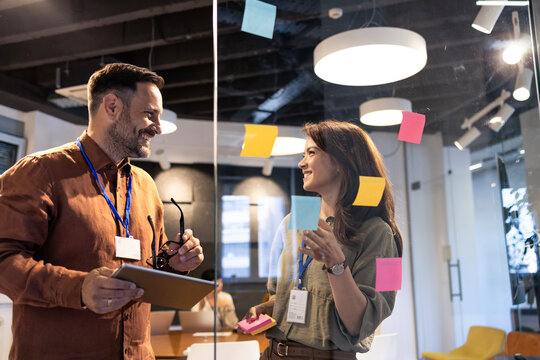 Diverse business team smiling and working together, sharing creative thoughts during a productive collaboration session