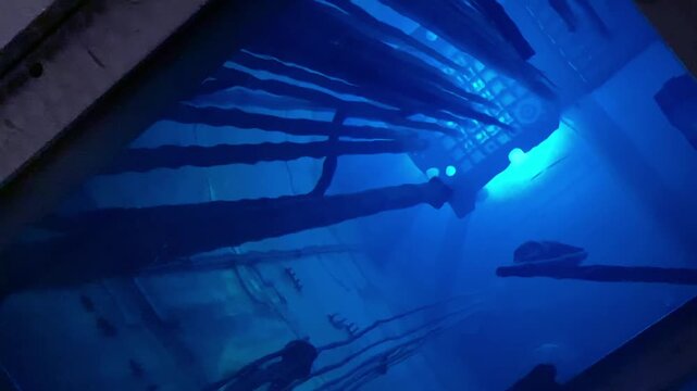 Blue glow water of nuclear reactor core powered, caused by Cherenkov radiation, fuel plates industrial uran.