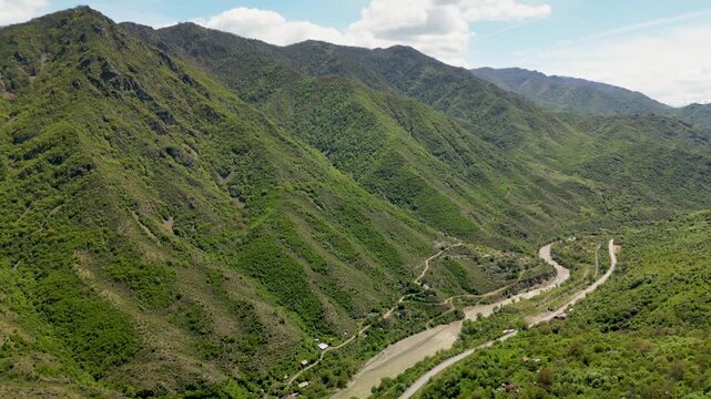 A scenic river gorge with steep cliffs and a winding river flowing through a mountainous landscape in northern Armenia.