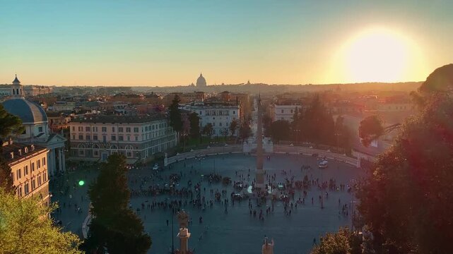 Motion tracking shot of crowded city square with obelisk and domed skyline in Italy Rome at sunset.
