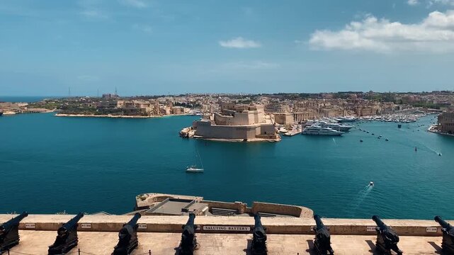 Sailboat in turquoise harbor waters of Valletta capital city of Malta.