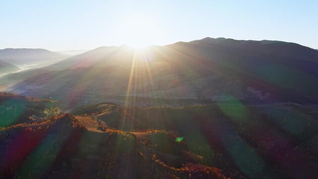 High mountains with terracota trees at bright sunrise