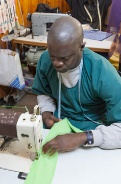 African Male Entrepreneur Sewing Fabric in a Local Micro Business Workshop