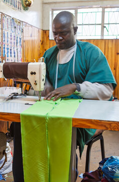 African Male Entrepreneur Sewing Fabric in a Local Micro Business Workshop