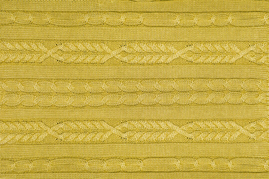Golden olive mustard knitted texture with cable knit ornament