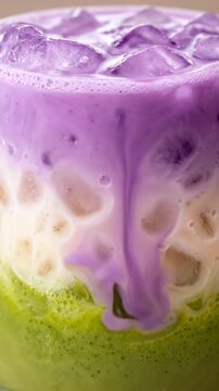 4K Macro close-up of layered iced ube and matcha latte with purple, white and green tones, vibrant cafe drink with purple yam and green tea, trendy wellness beverage for coffee shop menu

