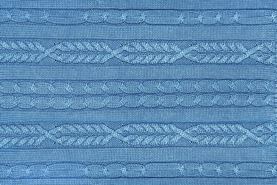 Classic blue knitted background with elegant cable stitch
