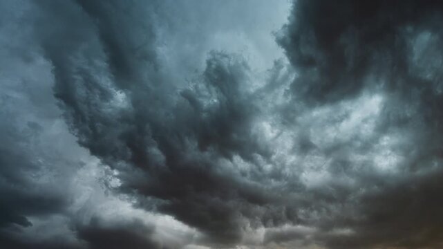 Fast moving thunderstorm clouds building in dark dramatic sky background