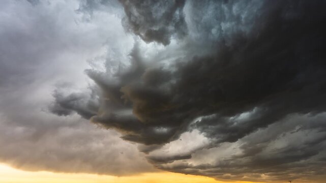 Moody dark clouds drifting across sky ahead of approaching storm