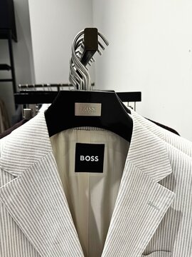 Moscow, Russia, May 11, 2026, Aviapark Shopping Center.
A WHITE STRIPED BLAZER FROM THE BOSS BRAND ON A HANGER. LUXURY FASHION CLOTHING IN A RETAIL STORE.