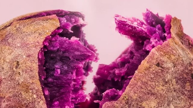Macro close up of baked ube purple yam root split open, vibrant purple superfood interior and roasted skin texture, healthy plant based ingredient for desserts and drinks, natural food
