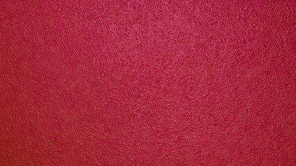 Fototapeta premium Detailed abstract background of a rough wooden surface painted in deep terracotta burgundy color. Textured matte finish of a red timber door