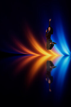 3D amber light leap with woman above reflective color beam